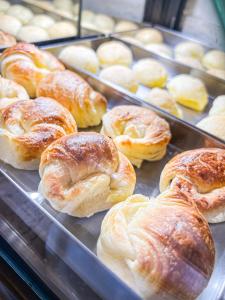 a bunch of pastries on trays in a display case at Pousada Cabanas Rota do Sol in Gramado