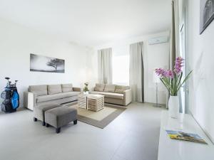a white living room with a couch and a chair at Villa Rita in Marsala