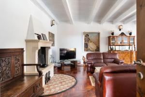 sala de estar con sofá y chimenea en Villa Carolina, en San Corrado di Fuori