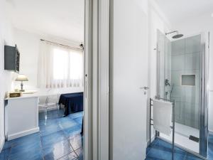 a bathroom with a glass door leading into a room at Spuma di Mare - Riccio in San Vito lo Capo