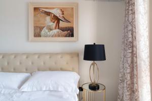 1 dormitorio con 1 cama y una pintura en la pared en Villa Anthea en Montallegro