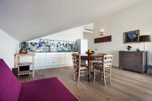 a kitchen and dining room with a table and chairs at Alyssa in Taormina