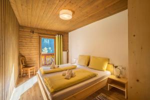 a bedroom with a bed with yellow sheets and a window at Ferienhaus Oberschneider in Selva dei Molini