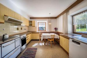 a kitchen with a table and chairs in it at Ferienhaus Oberschneider in Selva dei Molini +35 photos