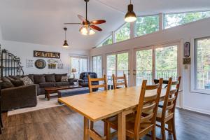 a dining room and living room with a table and chairs at Riverfront Brookston Retreat w/ Deck & River Tubes in Brookston