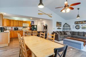a kitchen and a living room with a wooden table at Riverfront Brookston Retreat w/ Deck & River Tubes in Brookston +17 photos
