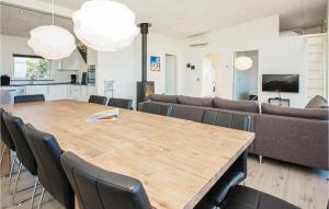 a dining room with a large wooden table and chairs at Four-Bedroom Holiday Home Haderslev With A Room Hot Tub 02 in Knud +14 photos