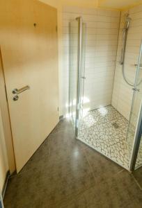 a bathroom with a shower with a glass door at Fleesensee 02 in Eldenburg