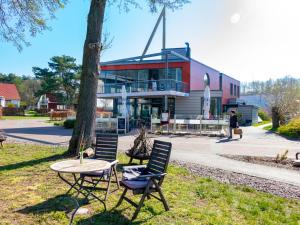 a table and chairs in front of a building at Fleesensee 02 in Eldenburg