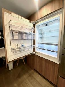 an empty refrigerator with its door open in a kitchen at Stylish Wicker Park Home in Chicago