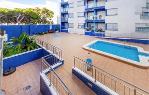 a swimming pool on the side of a building at Pet Friendly Apartment In Torrevieja in Torrevieja