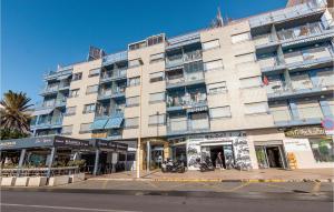 a large building on a street with motorcycles parked in front at Pet Friendly Apartment In Torrevieja in Torrevieja