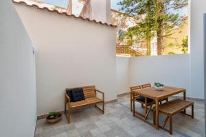 a dining room with a table and two chairs at RelaisApartments Centro in Alghero