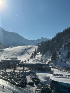 a parking lot with cars parked in the snow at Steinadler Gamsleiten FL - Skiing Holiday in Obertauern in Obertauern