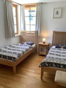 a bedroom with two beds and a window at Steinadler Gamsleiten FL - Skiing Holiday in Obertauern in Obertauern