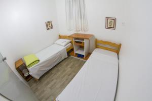 Ένα ή περισσότερα κρεβάτια σε δωμάτιο στο Pousada Polônia