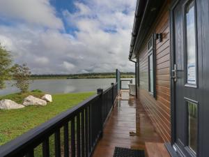 a balcony of a house with a view of a lake at 40 Delamere Point in Northwich