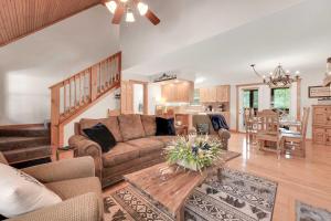 a living room with a couch and a table at Lakefront Branson Cabin 6 Mi to Branson Strip! in Branson West