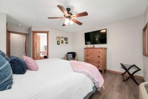 a bedroom with a bed and a ceiling fan at Lakefront Branson Cabin 6 Mi to Branson Strip! in Branson West