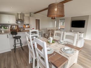a kitchen and dining room with a table and chairs at 44 Delamere Point in Northwich