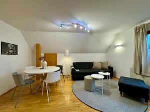 a living room with a couch and a table at Charmantes Bauernchalet Alois in Dornbirn