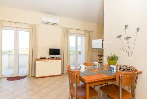 a kitchen and dining room with a table and chairs at Apartments Dadic in Cavtat