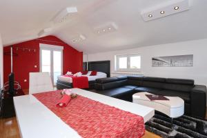 a living room with a couch and two beds at Apartments Maruna Self check-in in Zadar