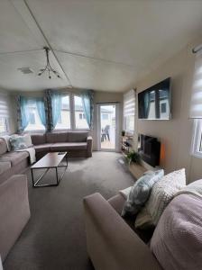 un soggiorno con due divani e una TV di At The Waters Edge ( Wansbeck View 26 ) a Newbiggin-by-the-Sea