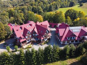 an aerial view of a large house with pink roofs at Hotel Jan in Szczawnica