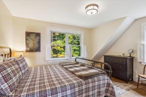 a bedroom with a bed and a window at The Sperry House in Stowe
