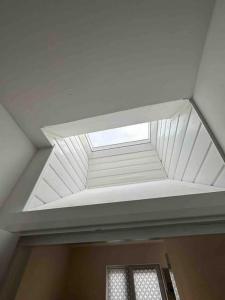 a skylight in the ceiling of a room at Gladys’ Apartment in Ponders End