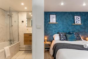 um quarto com uma cama king-size e uma casa de banho em Calliopée - Magnifique duplex, Gros Horloge Rouen em Rouen