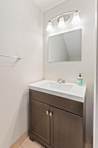 a bathroom with a sink and a mirror at Affordable 2-BR Heart of Detroit in Detroit