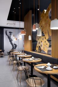 a row of tables and chairs in a restaurant at The Poet Hotel in La Spezia