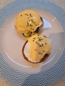 a sandwich with cheese and chives on a plate at Waterfront House in Dartmouth