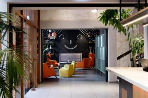 an office with orange chairs and a black wall at The Poet Hotel in La Spezia