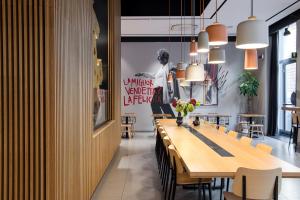 a dining room with a long table and chairs at The Poet Hotel in La Spezia