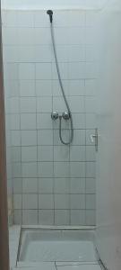 a shower with a hose in a bathroom at Friends house in Agadir