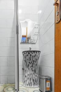a shower with a black and white chair in a bathroom at Ambrosia Heights in Entebbe