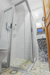 a shower with a glass door in a bathroom at Ambrosia Heights in Entebbe