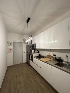 a kitchen with white cabinets and a counter top at Green Apartment in Pioltello