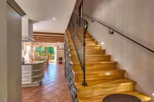 a staircase in a home with a kitchen at Mountain house Rupicapra with Sauna and Outdoor Hot Tub in Kostel