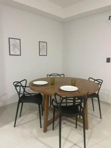 a wooden table with four chairs around it at DEPARTAMENTO CENTRICO in San Fernando del Valle de Catamarca