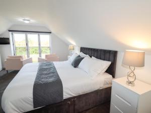 a bedroom with a large bed and a window at Maritos in Holywell