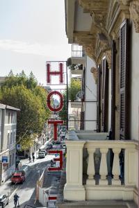 a building with a clock on the side of a street at The Poet Hotel in La Spezia