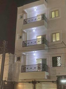 a white building with balconies on the side of it at RÈSIDENCE NGUARY in Dakar