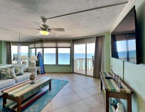 a living room with a couch and a table at Oceanside Retreat 804 in Ormond Beach