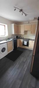 a kitchen with a sink and a washer and dryer at One bedroom with Great city views in London