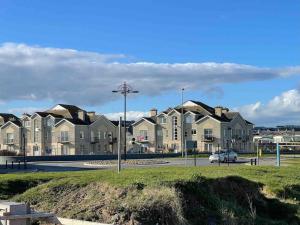 a row of houses in a parking lot at Coastal Apartment Tramore in Waterford