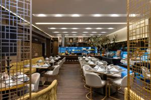 a dining room with tables and chairs and a restaurant at Hotel 93 Luxury Suites by Preferred in Bogotá +51 photos